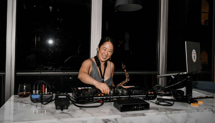 DJ performing live with saxophone at event