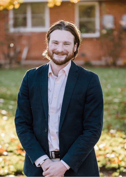 Archibald The Celebrant — male wedding celebrant smiling outdoors in navy blazer