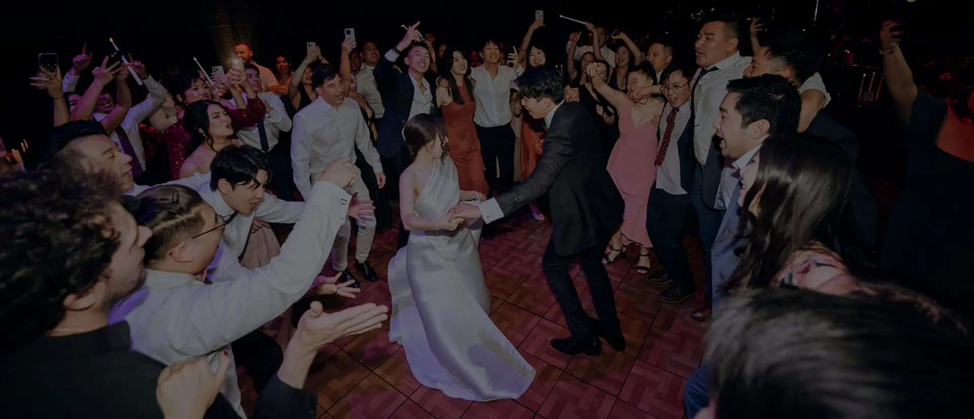 DJ Emily Gracie performing at a Melbourne wedding reception with guests dancing