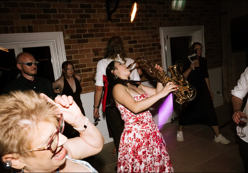 Yarra Valley wedding DJ Emily Gracie playing live saxophone for guests on the dance floor