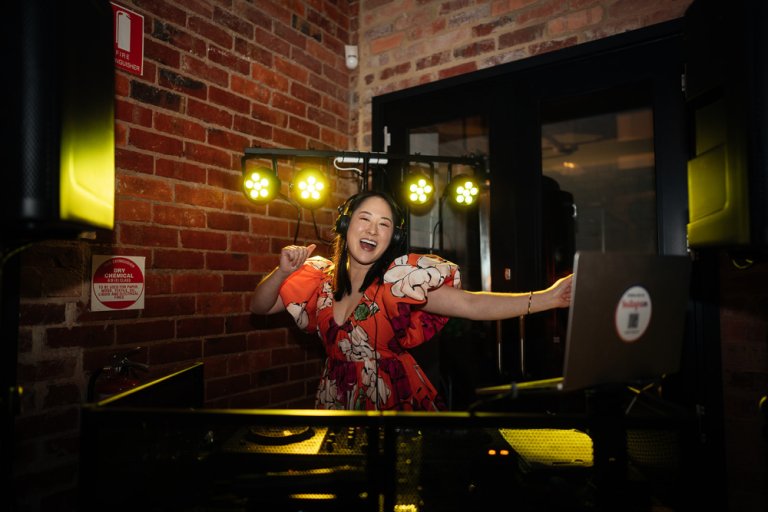 DJ Emily Gracie at the decks with LED lighting — professional DJ equipment Melbourne