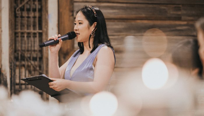 DJ Emily Gracie acting as MC at a private event in Melbourne