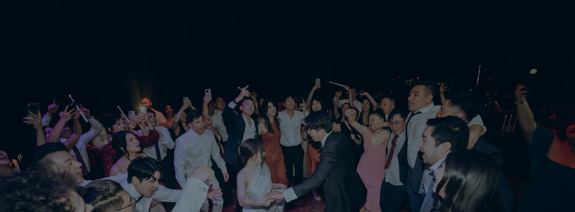 Packed dance floor at a Melbourne event with guests celebrating — DJ Emily Gracie