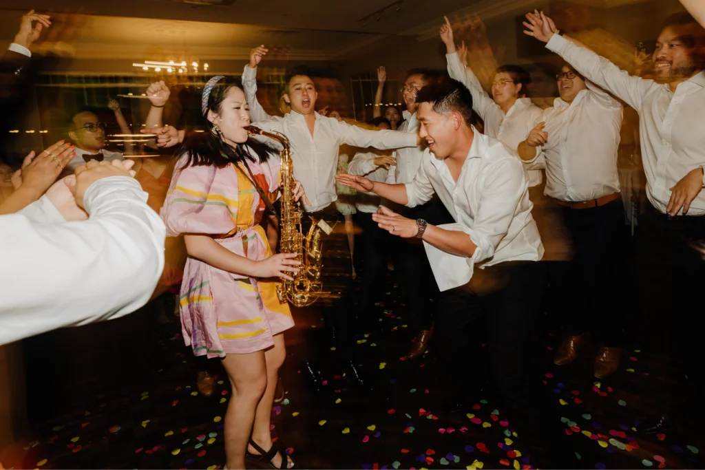 Emily Gracie playing saxophone on the wedding dance floor